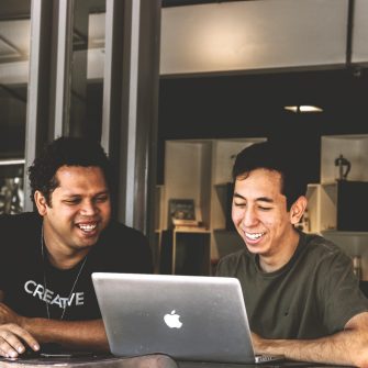 Two people looking at laptop screen