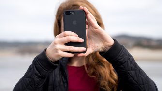 Young woman taking a photo with a phone