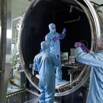 Engineers from the UNSW Canberra Space team work at the National Space Test Facility at Mt Stromlo during testing for the M2 mission.