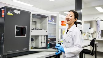 A laboratory technician working with engineering equipment