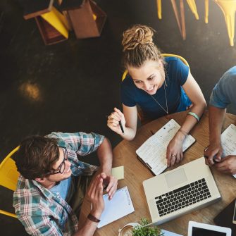 High angle shot of a group of students studying in a coffee shop