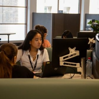 A student engaged in conversation with a student advisor