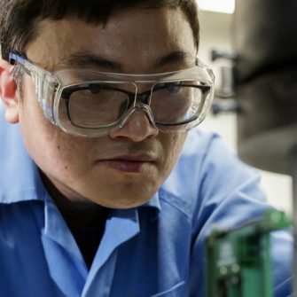 Civil Engineering student conducting concrete compression test