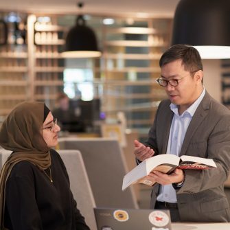 Law student and teacher in Law Library study space