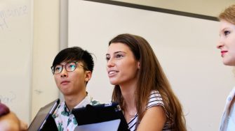 Students take notes on tablets in a classroom scenario