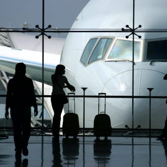 Three people waiting to board an aeroplane