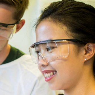 Students in lab looking at tissue culture tube