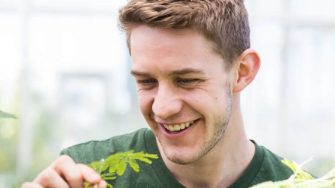 Man smiling in glasshouse