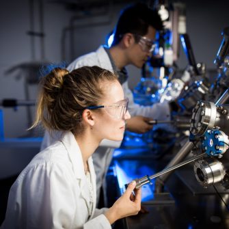 female scientist testing machine