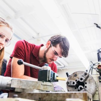 Engineers working on a heavy machinery for their project work