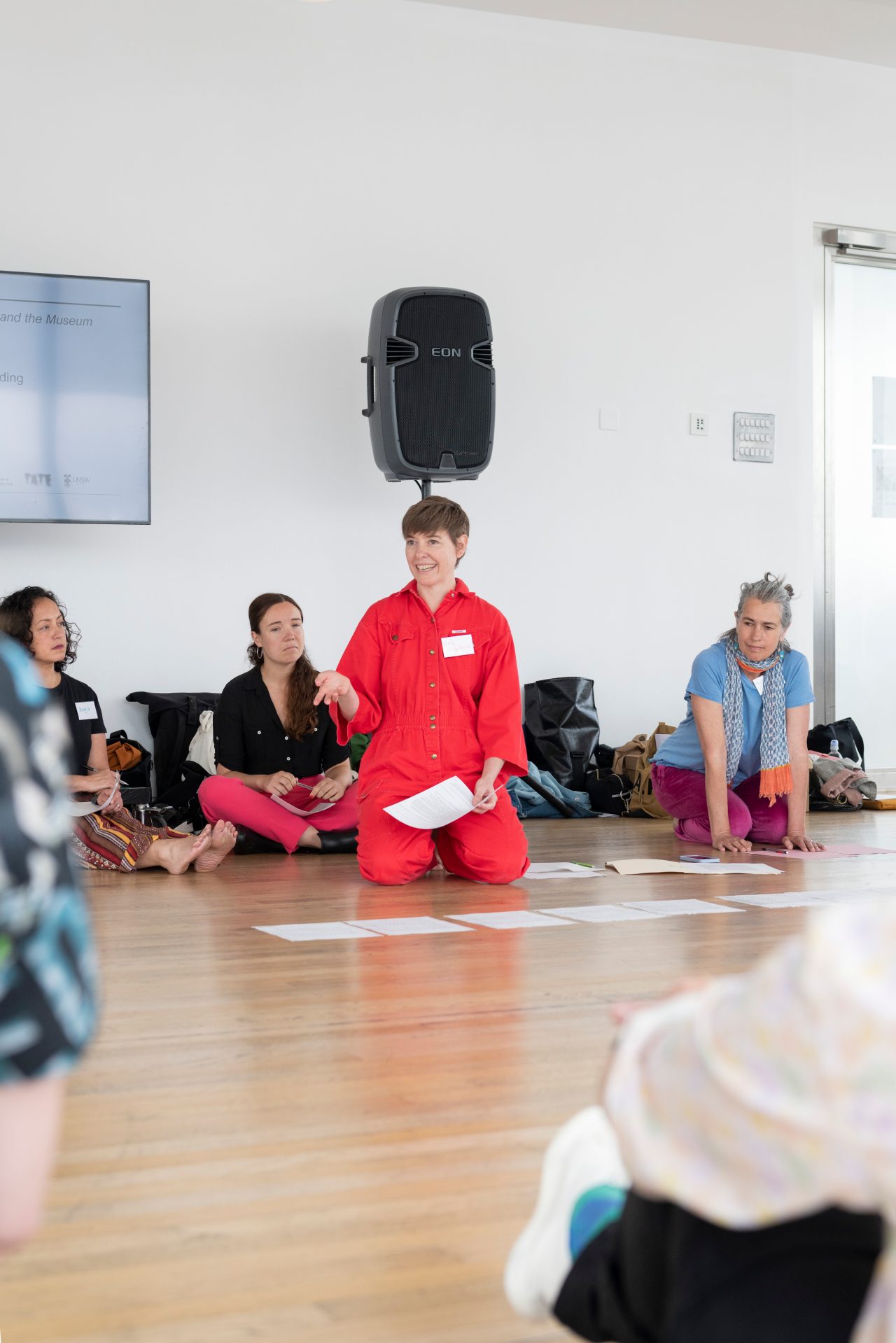 People sitting on the floor in discussion