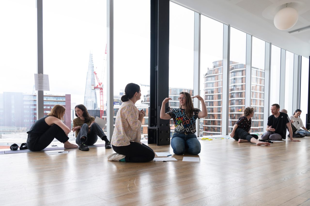 People sitting on the floor in discussion