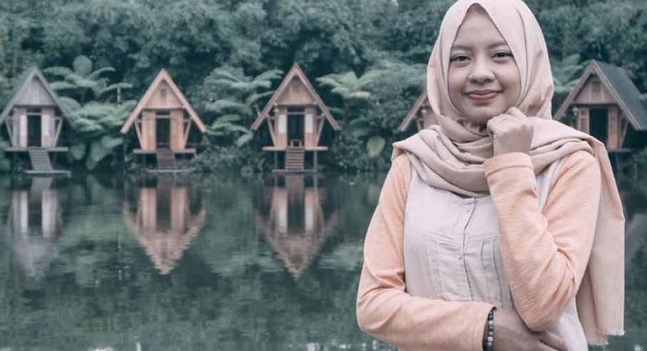 Lady in front of lake cottages