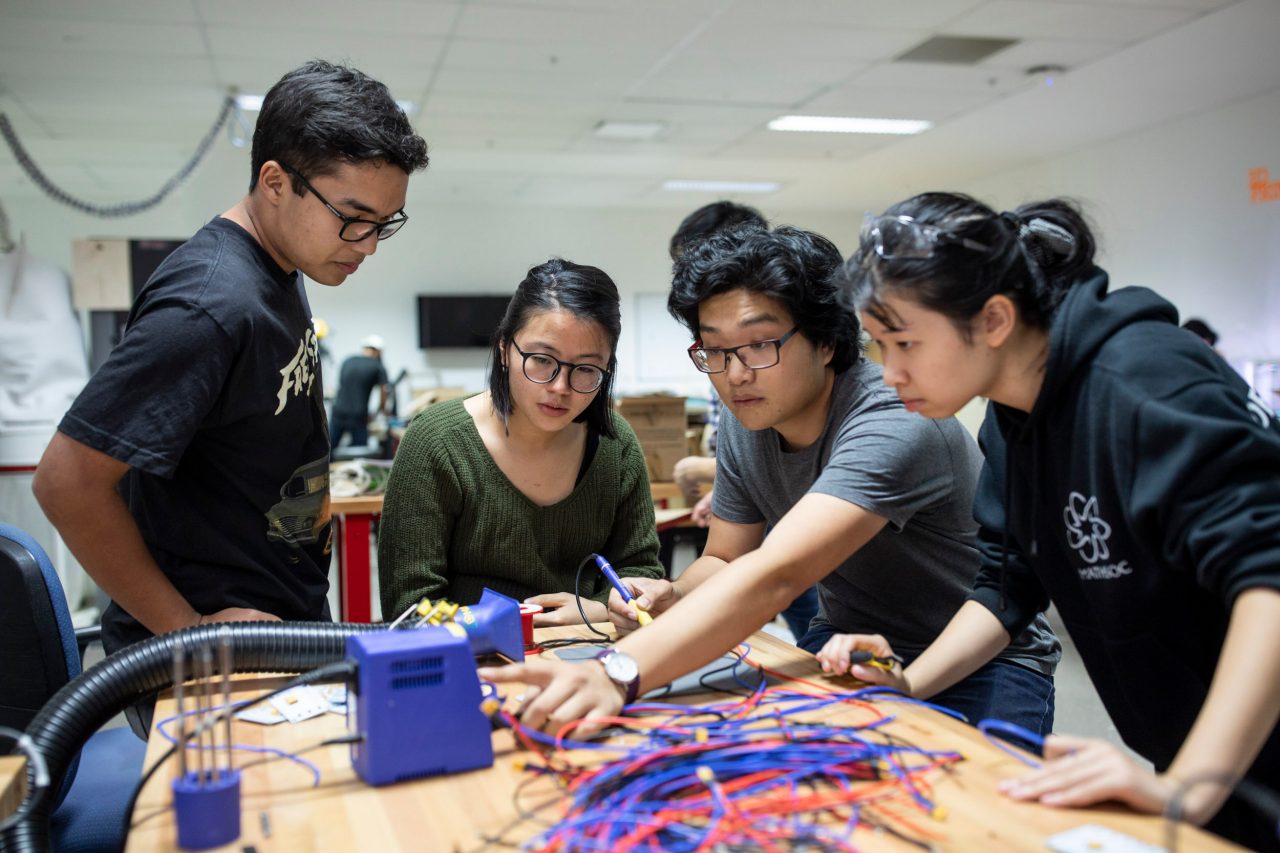 Students working on vivid light installation