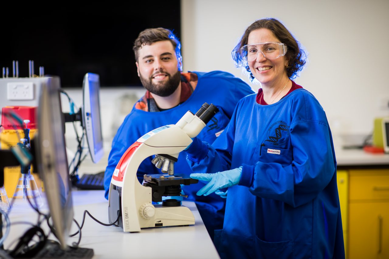 Photograph of students using microscope